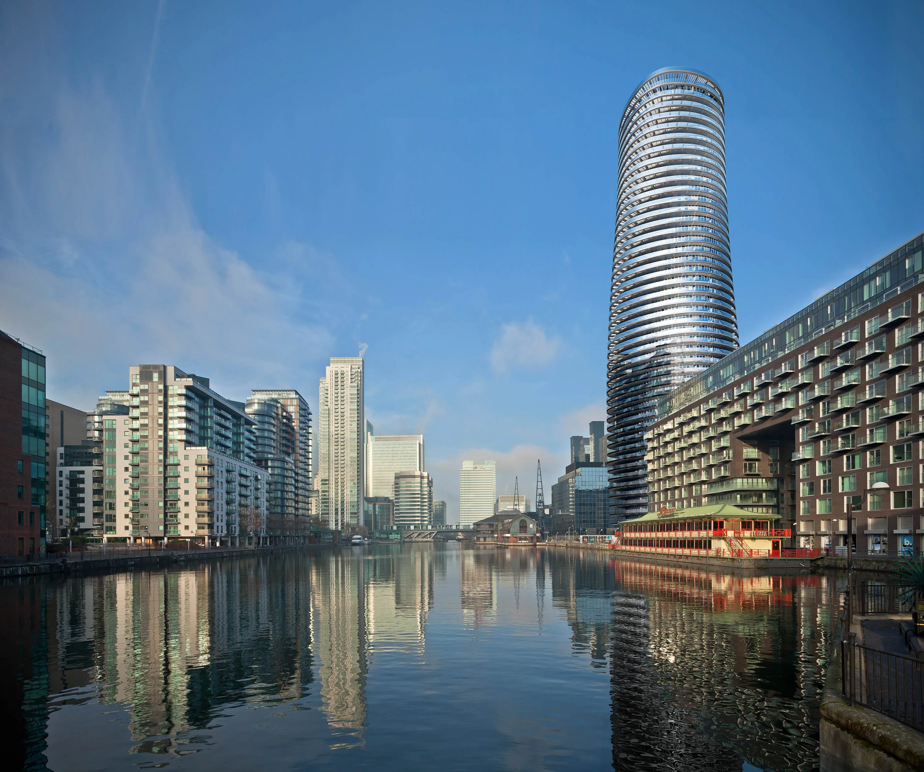 Baltimore Tower seen across the dock — Everform anodised aluminium soffits and curved facade, Canary Wharf