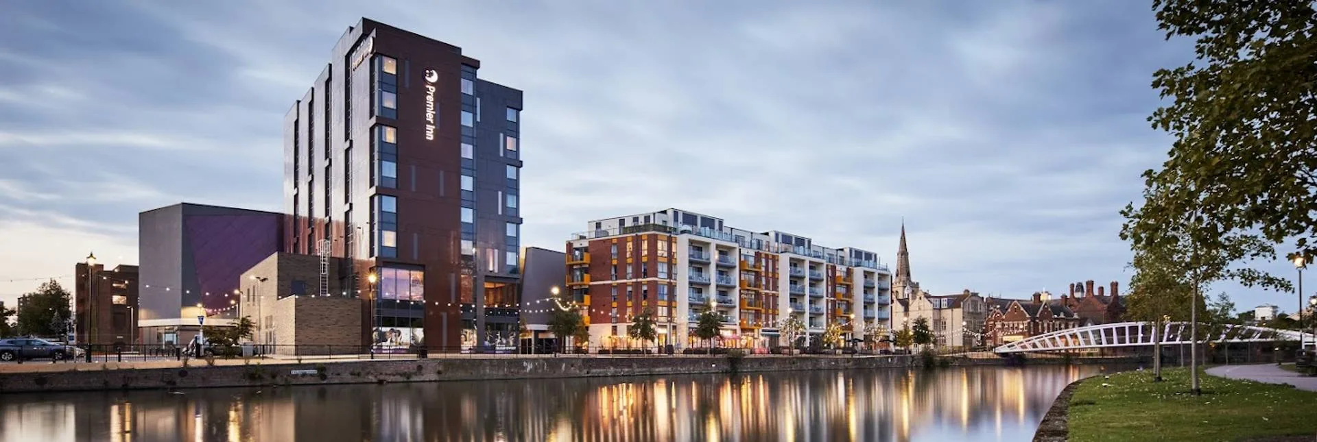 Premier Inn Bedford at dusk — Everform Vitrabond A2 reclad on the riverside
